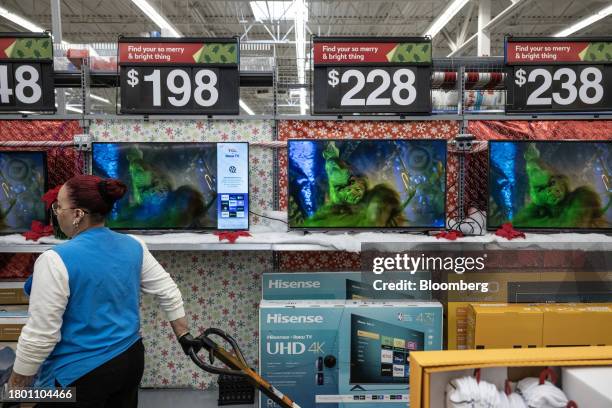 Worker stocks televisions at a Walmart store on Black Friday in Secaucus, New Jersey, US, on Friday, Nov. 24, 2023. An estimated 182 million people...