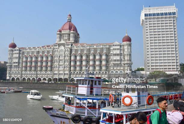 Tourists outside the Taj Mahal Palace hotel, one of the sites of the 26/11, 2008 Mumbai terror attacks, on the eve of the anniversary of the gruesome...