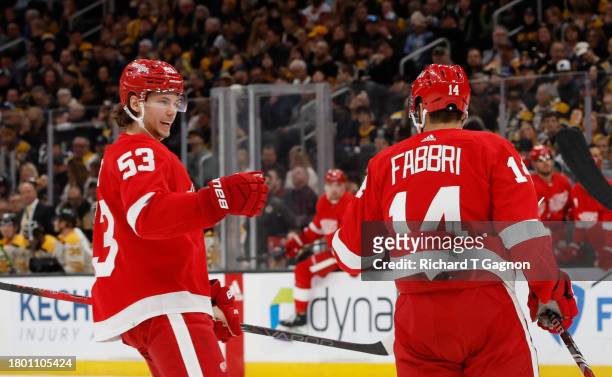 Robby Fabbri of the Detroit Red Wings celebrates with teammate Moritz Seider after he scored against Jeremy Swayman of the Boston Bruins during the...