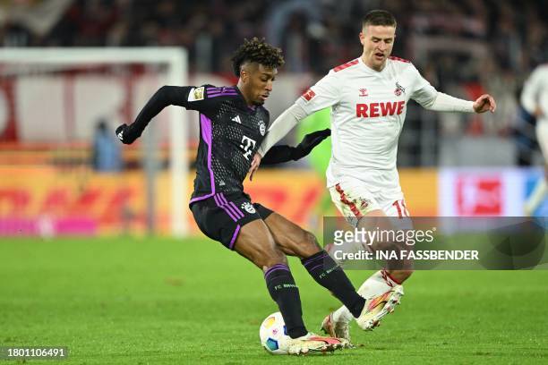 Bayern Munich's French forward Kingsley Coman and Cologne's Danish defender Rasmus Carstensen vie for the ball during the German first division...