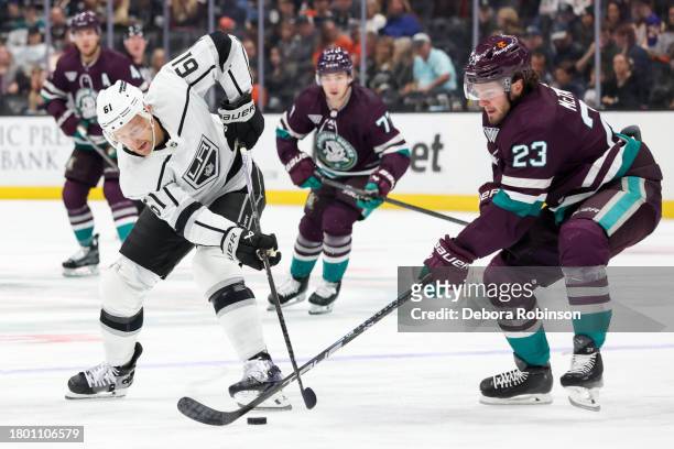 Trevor Lewis of the Los Angeles Kings and Mason McTavish of the Anaheim Ducks battle for the puck during the first period at Honda Center on November...