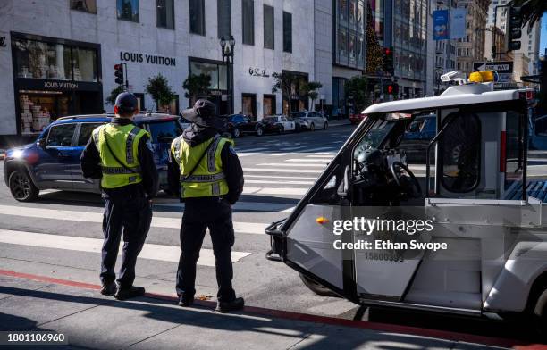 Police monitor as shoppers walk past stores on November 24, 2023 in Union Square, San Francisco, California. The National Retail Federation projects...