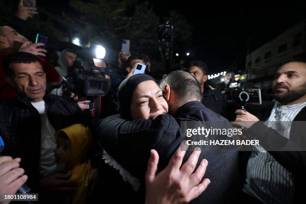 Rawda Abu Ajamieh hugs relatives and friends after her release from an Israeli prison as part of a truce agreement between Israel and Hamas in the...