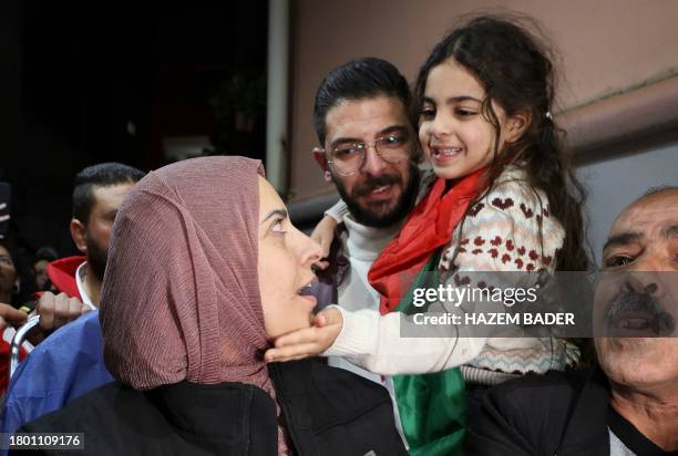 Fatima Shaheen' daughter Aylool gently caresses her mother's cheek after her release from an Israeli prison as part of a truce agreement between...