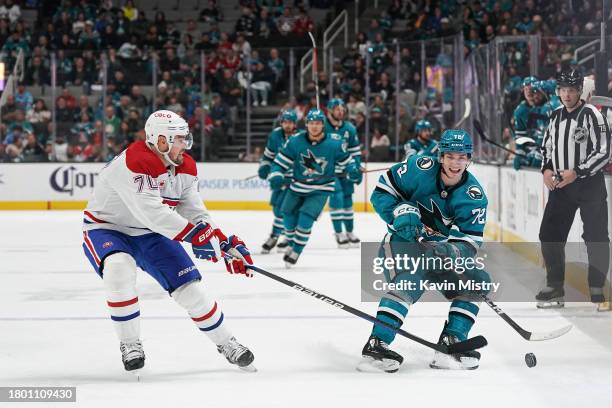 William Eklund of the San Jose Sharks skates ahead with the puck against Tanner Pearson of the Montreal Canadiens at SAP Center on November 24, 2023...