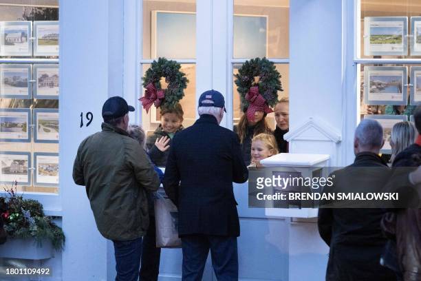 President Joe Biden with son Hunter Biden and grandson Beau Biden stop to greet people as they walk while shopping with family members in downtown...