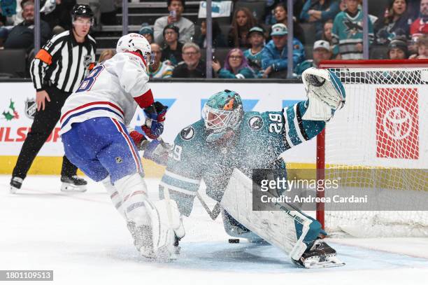 November 24: Mackenzie Blackwood of the San Jose Sharks making a save against Christian Dvorak of the Montreal Canadiens in overtime at SAP Center on...