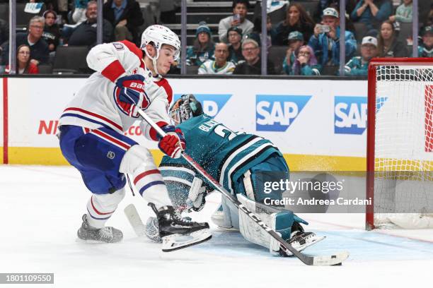 November 24: Mackenzie Blackwood of the San Jose Sharks making a save against Juraj Slafkovsky of the Montreal Canadiens in overtime at SAP Center on...