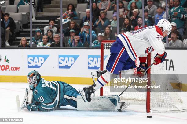 November 24: Mackenzie Blackwood of the San Jose Sharks making a save against Juraj Slafkovsky of the Montreal Canadiens in overtime at SAP Center on...