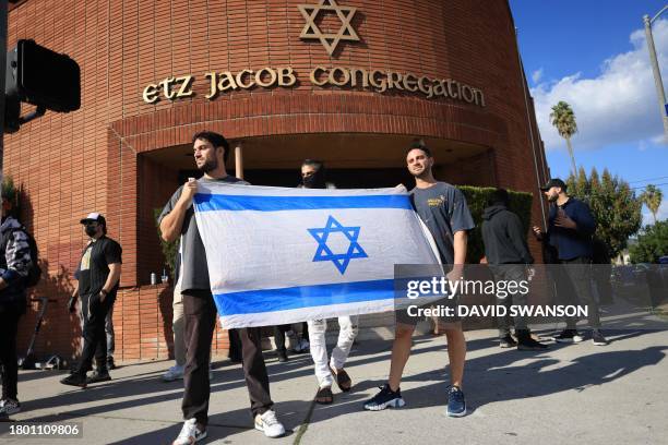 Men protect Etz Jacob synagogue as Pro-Palestinian supporters disrupt shoppers during Black Friday sales near The Grove, a high end shopping center,...