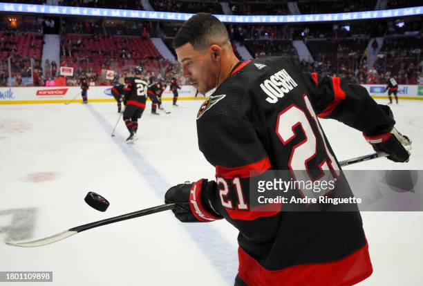 Mathieu Joseph of the Ottawa Senators juggles the puck during warm-up prior to a game against the New York Islanders at Canadian Tire Centre on...