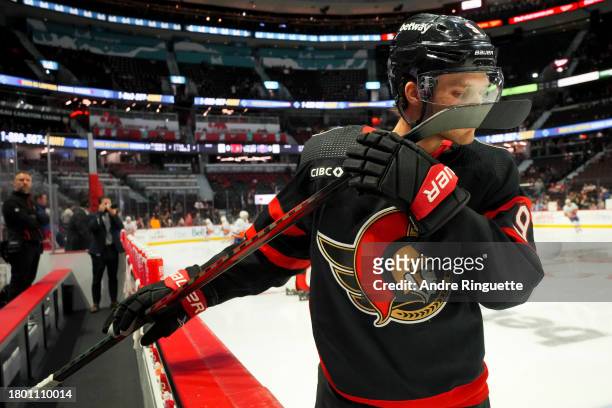 Josh Norris of the Ottawa Senators smells his stick during warm-up prior to a game against the New York Islanders at Canadian Tire Centre on November...