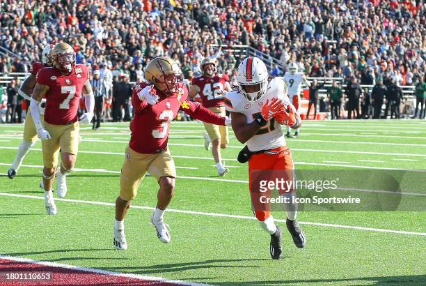 Miami Hurricanes running back Henry Parrish Jr. Runs with the ball pursued by Boston College Eagles defensive back Khari Johnson during the college...