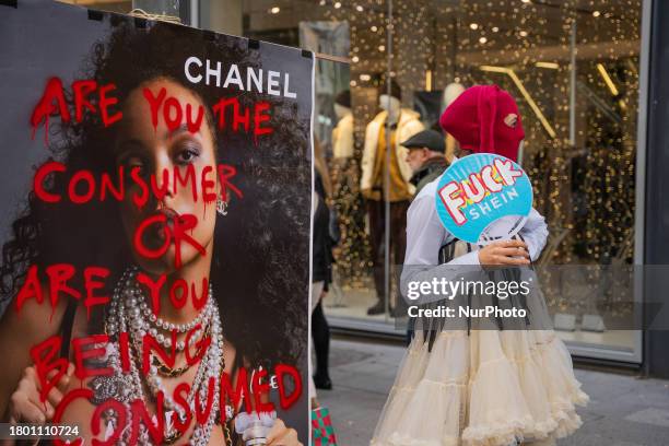 Group of capitalist activists are performing and giving away clothes during Black Friday in Barcelona, Spain, on November 24, 2023. They are...