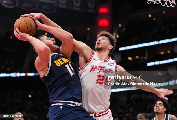 Alperen Sengun of the Houston Rockets attempts to block the shot of Nikola Jokic of the Denver Nuggets in the first quarter of an NBA In-Season...