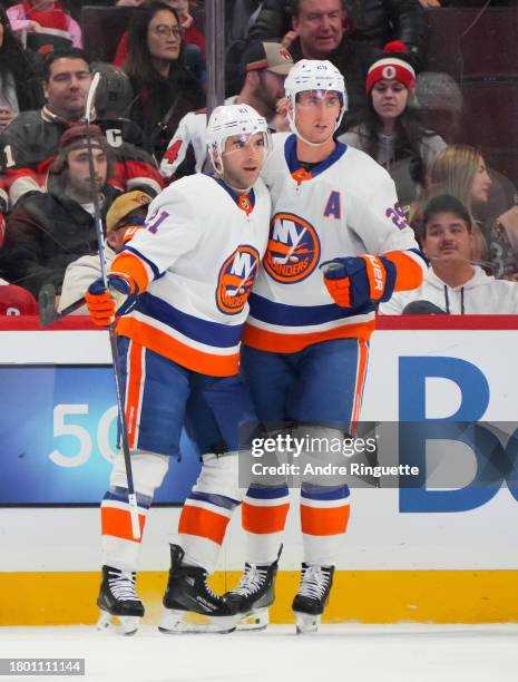 Kyle Palmieri of the New York Islanders celebrates his first period goal against the Ottawa Senators with teammate Brock Nelson at Canadian Tire...