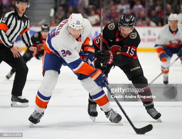 Matthew Highmore of the Ottawa Senators battles for puck possession against Scott Mayfield of the New York Islanders during the first period at...