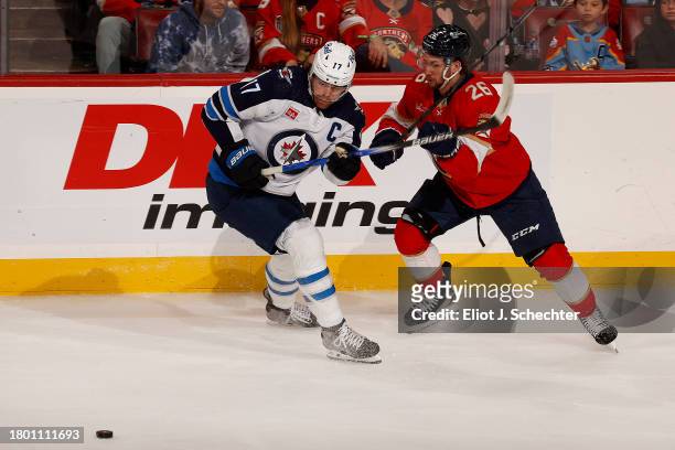 Uvis Balinskis of the Florida Panthers tangles with Adam Lowry of the Winnipeg Jets at the Amerant Bank Arena on November 24, 2023 in Sunrise,...