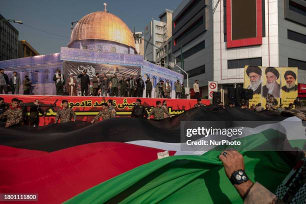 Members of the Basij paramilitary force, which is under the command of the Islamic Revolutionary Guard Corps , are carrying a massive Palestinian...