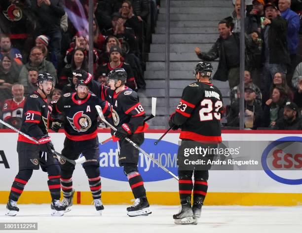 Tim Stützle of the Ottawa Senators celebrates his second period goal against the New York Islanders with teammates Mathieu Joseph, Claude Giroux and...