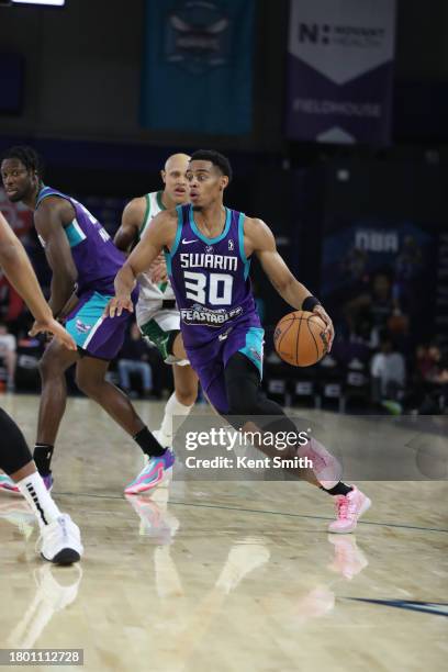 November 24: Jaylen Sims of the Greensboro Swarm drivess against Jordan Walsh of the Maine Celtics on November 24, 2023 at The Novant Health...