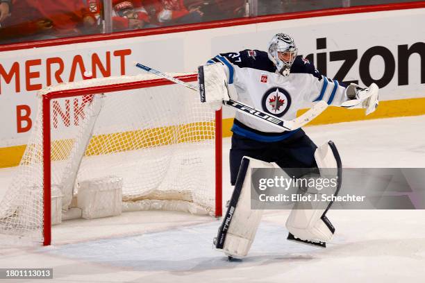 Goaltender Connor Hellebuyck of the Winnipeg Jets celebrates their 3-0 shut out win against the Florida Panthers at the Amerant Bank Arena on...