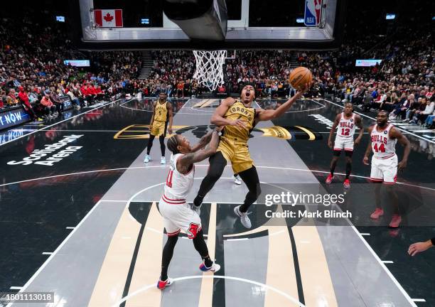 Scottie Barnes of the Toronto Raptors goes to the basket against DeMar DeRozan of the Chicago Bulls during the second half of the NBA In-Season...