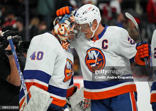Anders Lee of the New York Islanders celebrates with goalie Semyon Varlamov after their teams' 5-3 win against the Ottawa Senators at Canadian Tire...