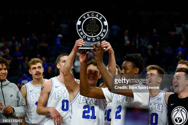 Brigham Young University Cougars guard Trevin Knell and Jaxson Robinson hold up the trophy after winning the championship game of the Vegas Showdown...