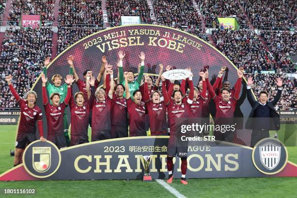 Members of Vissel Kobe celebrate their J-League title following a 2-1 victory over Nagoya Grampus in their J-League first division football match in...