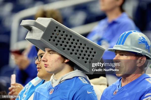 A fan with a cheese grater hat looks onto the field during an NFL News  Photo - Getty Images