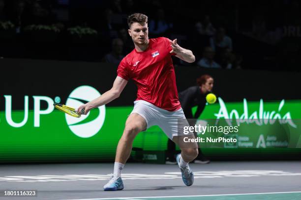 Miomir Kecmanovic of Serbia is playing a forehand during the quarterfinal match against Jack Draper of Great Britain at the Davis Cup in Malaga,...