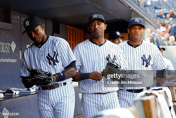 Alfonso Soriano , Eduardo Nunez and Robinson Cano of the New York Yankees look on before a game against the Toronto Blue Jays at Yankee Stadium on...