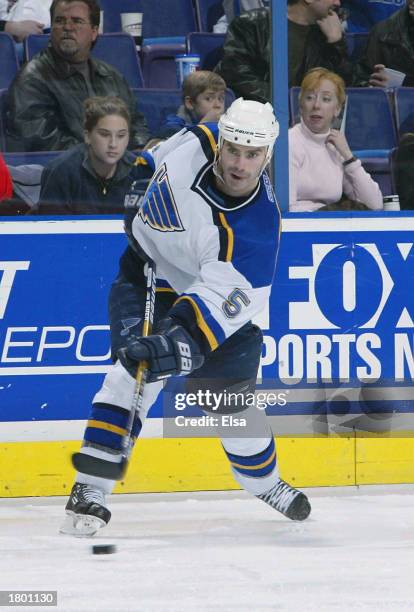 Barret Jackman of the St. Louis Blues takes a shot against the Calgary Flames on February 17, 2003 at the Savvis Center in St. Louis, Missouri. The...