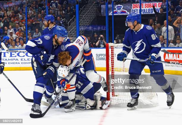 Victor Hedman of the Tampa Bay Lightning knocks the helmet off Leon Draisaitl of the Edmonton Oilers during the third period at Amalie Arena on...