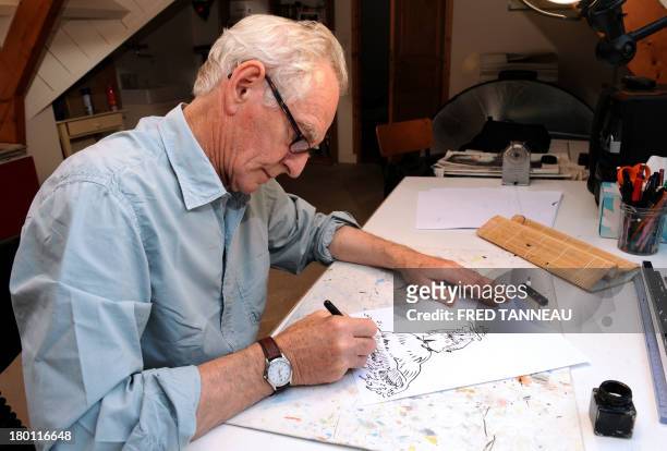 French satirical and political cartoonist Rene Petillon draws hero detective Jack Palmer on September 3, 2013 in Nevez, western France. Petillon's...