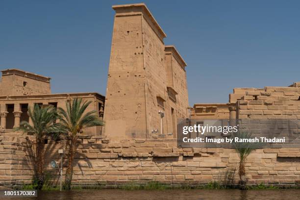 first pylon of the temple of philae seen from the nile - island of agilika imagens e fotografias de stock