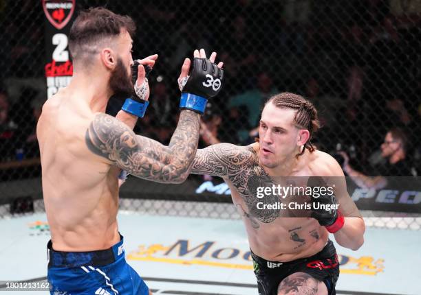 Brendan Allen punches Paul Craig of Scotland in a middleweight fight during the UFC Fight Night event at UFC APEX on November 18, 2023 in Las Vegas,...