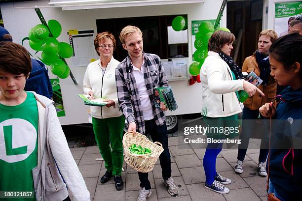 Political campaigners for the Centre Party hand out pamphlets to passing pedestrians ahead of national elections in Trondheim, Norway, on Saturday,...