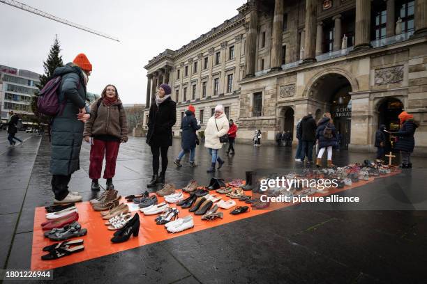 November 2023, Lower Saxony, Brunswick: Symbolically, 113 pairs of shoes, representing the 113 women who were killed by their partners in 2021, stand...