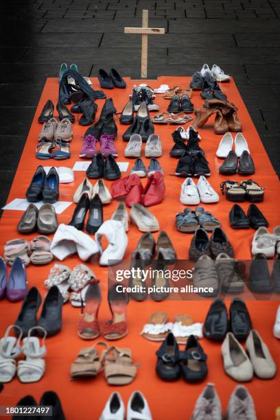 November 2023, Lower Saxony, Brunswick: Symbolically, 113 pairs of shoes, representing the 113 women who were killed by their partners in 2021, stand...