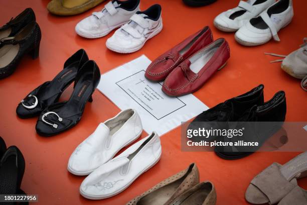 November 2023, Lower Saxony, Brunswick: Pairs of shoes, representing the 113 women who were killed by their partners in 2021, are symbolically placed...