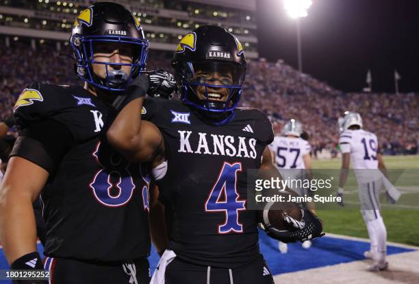 Running back Devin Neal of the Kansas Jayhawks celebrates with tight end Mason Fairchild after a touchdown during the 1st half of the game against...
