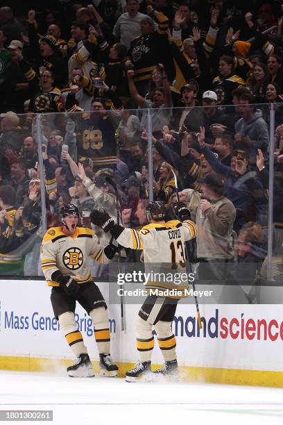 Trent Frederic of the Boston Bruins celebrates with Charlie Coyle after scoring against the Montreal Canadiens during the second period at TD Garden...