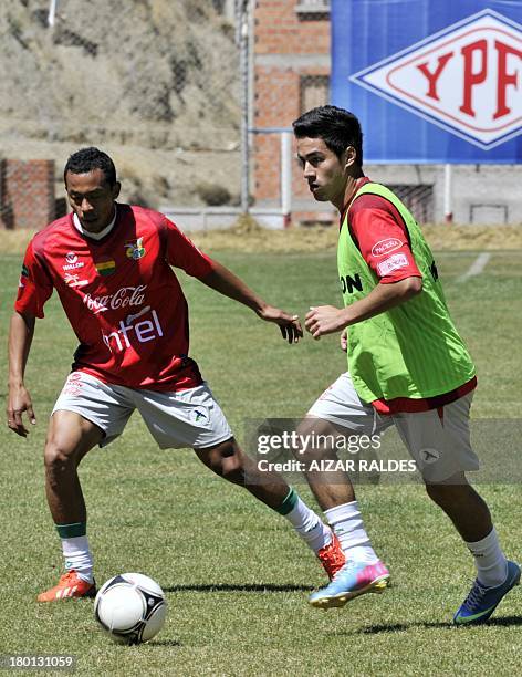 Bolivia's national football team players Edemir Rodriguez and Rodrigo Ramallo participate in a training session in La Paz on September 09, 2013....