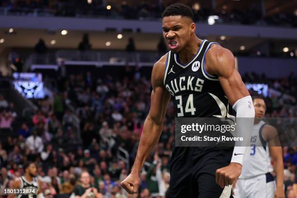 Giannis Antetokounmpo of the Milwaukee Bucks reacts to a dunk against the Dallas Mavericks during the first half of a game at Fiserv Forum on...