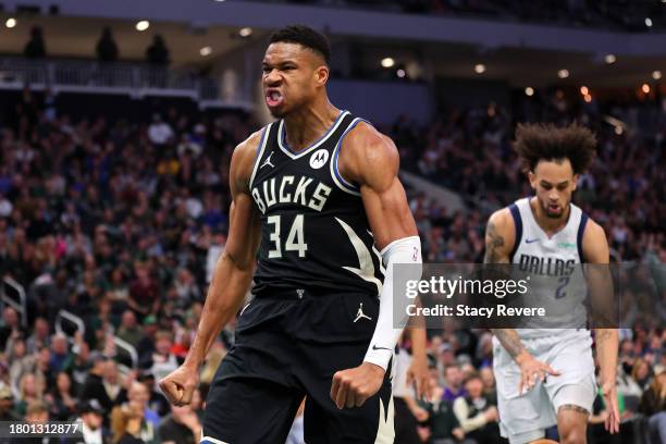 Giannis Antetokounmpo of the Milwaukee Bucks reacts to a dunk against the Dallas Mavericks during the first half of a game at Fiserv Forum on...