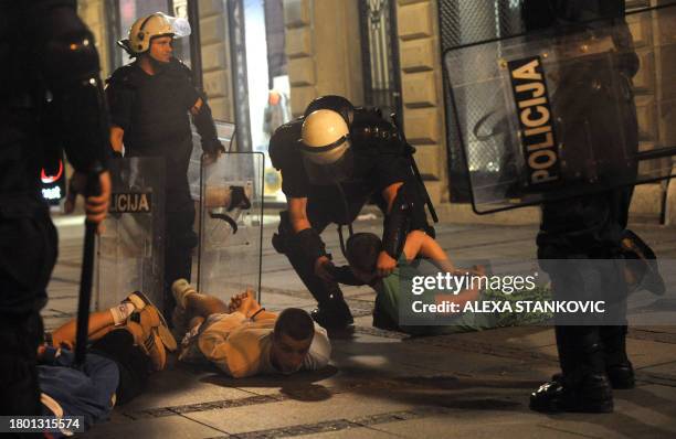 Demonstrators are arrested by riot policemen on the sidelines of a demonstration in front of Serbian Parliament on May 29, 2011 in Belgrade, called...