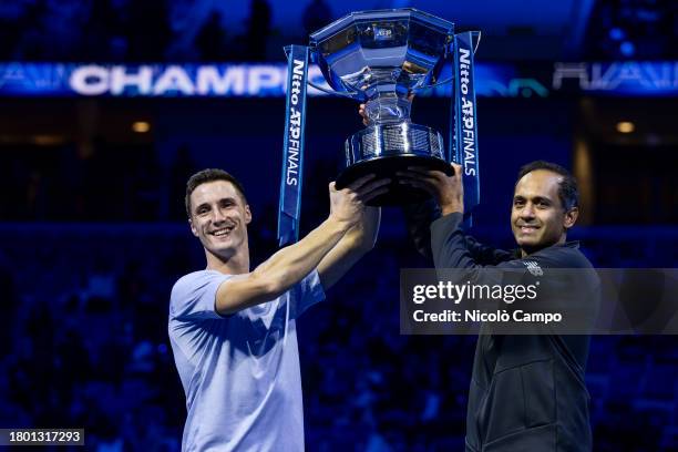 Rajeev Ram of USA and Joe Salisbury of Great Britain lift the trophy at the end of the final doubles match against Marcel Granollers of Spain and...