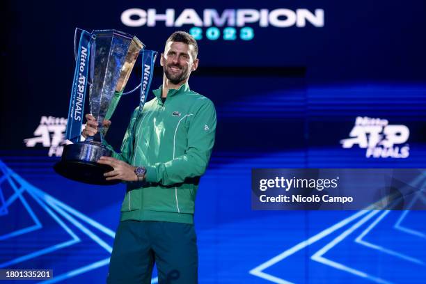 Novak Djokovic of Serbia poses for a photo with the trophy at the end of the final singles match against Jannik Sinner of Italy during day eight of...